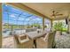 Covered patio featuring a wicker dining set and stylish stone flooring, perfect for outdoor entertaining at 9136 Warm Springs Cir, Parrish, FL 34219