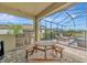 Outdoor kitchen and screened in patio area featuring a grill, picnic table, and access to pool and spa at 9136 Warm Springs Cir, Parrish, FL 34219