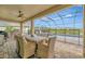 Relaxing patio features a dining table with seating, an outdoor grill, and scenic backyard views of the pool at 9136 Warm Springs Cir, Parrish, FL 34219