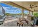 Spacious outdoor patio featuring a grill, dining table, and lounge chairs, perfect for entertaining at 9136 Warm Springs Cir, Parrish, FL 34219