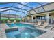 Backyard pool and spa enclosed with screen with outdoor lounge area and lake views at 9136 Warm Springs Cir, Parrish, FL 34219