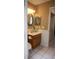 Charming half bath with wooden vanity and updated fixtures at 10402 Ashley Oaks Drive, Riverview, FL 33578