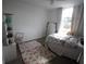 A bright, carpeted bedroom featuring a charming chair and a decorative rug at 10402 Ashley Oaks Drive, Riverview, FL 33578