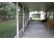 Covered screened patio with chairs and peaceful backyard views at 10402 Ashley Oaks Drive, Riverview, FL 33578