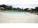 Community in-ground pool with lounge chairs, tables, and sun umbrellas at 10402 Ashley Oaks Drive, Riverview, FL 33578