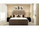 Tastefully decorated bedroom featuring a plush bed, matching lamps, neutral tones, and modern artwork at 11990 Brae Way, Dade City, FL 33525