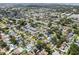 Expansive aerial view of a residential neighborhood with mature trees, well-maintained homes, and community features at 12359 82Nd N Ave, Seminole, FL 33772