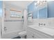 Bathroom with a bathtub, tile backsplash, vanity storage, and window at 12359 82Nd N Ave, Seminole, FL 33772