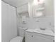 Clean bathroom with white tile, traditional fixtures, and vanity storage at 12359 82Nd N Ave, Seminole, FL 33772