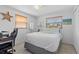 Well-lit bedroom with a desk, hardwood floors, ceiling fan, and natural light at 12359 82Nd N Ave, Seminole, FL 33772