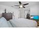 Spacious bedroom with a ceiling fan, sliding glass closet, and hardwood dresser at 12359 82Nd N Ave, Seminole, FL 33772