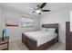 Bedroom showcasing a wooden bed frame, ceiling fan, and natural light from the window at 12359 82Nd N Ave, Seminole, FL 33772