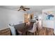 Features a dining area with light walls, a dark wood table, and hardwood floors leading to the kitchen at 12359 82Nd N Ave, Seminole, FL 33772