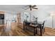 A dining room with hardwood floors, a ceiling fan, and natural lighting creating a warm and inviting atmosphere at 12359 82Nd N Ave, Seminole, FL 33772