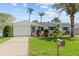 Charming single-story home with lush landscaping, a well-manicured lawn, and a welcoming entrance at 12359 82Nd N Ave, Seminole, FL 33772