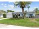 Charming single-story home with a well-manicured lawn, mature palm tree, and bright blue shutter accents at 12359 82Nd N Ave, Seminole, FL 33772