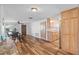 Spacious dining area with wood floors leads to a kitchen with granite countertops and wood cabinets at 12359 82Nd N Ave, Seminole, FL 33772