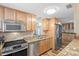 Modern kitchen with stainless steel appliances, granite countertops, and custom cabinetry at 12359 82Nd N Ave, Seminole, FL 33772