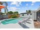 Relaxing backyard pool with lounge chairs and a white privacy fence, perfect for outdoor enjoyment at 12359 82Nd N Ave, Seminole, FL 33772