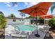 Backyard oasis features a sparkling pool, lounge chairs, and a covered patio for ultimate relaxation and outdoor entertaining at 12359 82Nd N Ave, Seminole, FL 33772