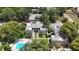 An aerial view of the apartment complex shows the community pool, parking lot and lush landscaping on a sunny day at 125 Picardy Villa Cir # 100, Brandon, FL 33510