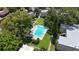 Bright blue pool surrounded by verdant green lawn and trees within this community at 125 Picardy Villa Cir # 100, Brandon, FL 33510