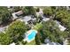 An aerial view of the apartment complex shows the community pool, lush landscaping and building facades at 125 Picardy Villa Cir # 100, Brandon, FL 33510