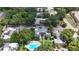An aerial view of the apartment complex shows the community pool, parking lot and lush landscaping on a sunny day at 125 Picardy Villa Cir # 100, Brandon, FL 33510
