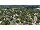 An aerial view showing houses with pools surrounded by trees in a lush and green community at 125 Picardy Villa Cir # 100, Brandon, FL 33510
