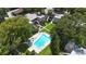 An aerial view of the apartment complex shows the community pool, lush landscaping and building facades at 125 Picardy Villa Cir # 100, Brandon, FL 33510