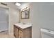 Bathroom featuring modern vanity with updated fixtures, framed mirror, and tiled floor at 125 Picardy Villa Cir # 100, Brandon, FL 33510
