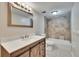 Bathroom featuring tiled shower, modern vanity with updated fixtures and framed mirror at 125 Picardy Villa Cir # 100, Brandon, FL 33510