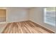 Bedroom showcasing light wood flooring, a window, and decorative screen door at 125 Picardy Villa Cir # 100, Brandon, FL 33510