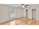 This bedroom features wood floors, a ceiling fan, and a window at 125 Picardy Villa Cir # 100, Brandon, FL 33510