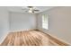 This bedroom features wood floors, a ceiling fan, and a window at 125 Picardy Villa Cir # 100, Brandon, FL 33510