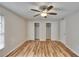 This bedroom features wood floors, a ceiling fan, and double closets at 125 Picardy Villa Cir # 100, Brandon, FL 33510