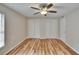 This bedroom features wood floors, a ceiling fan, and double closets at 125 Picardy Villa Cir # 100, Brandon, FL 33510