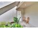 Inviting front door entrance with two wooden chairs and lush landscaping at 125 Picardy Villa Cir # 100, Brandon, FL 33510