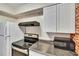 The kitchen is equipped with stainless steel appliances, white cabinets, and granite countertops at 125 Picardy Villa Cir # 100, Brandon, FL 33510