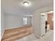 Bright living room with light wood floors, a large window, and access to the kitchen at 125 Picardy Villa Cir # 100, Brandon, FL 33510