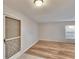 Open-concept living space featuring light wood floors and a decorative screen door at 125 Picardy Villa Cir # 100, Brandon, FL 33510