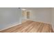 Spacious room featuring light wood flooring leading to the entry door at 125 Picardy Villa Cir # 100, Brandon, FL 33510