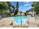 A community swimming pool surrounded by lush trees and apartment buildings offers a great place to relax and enjoy the outdoors at 125 Picardy Villa Cir # 100, Brandon, FL 33510