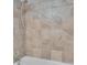 Close up of tiled shower over tub with brushed nickel shower head and fixtures at 125 Picardy Villa Cir # 100, Brandon, FL 33510