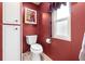 Compact bathroom with a toilet, small window and cabinet for storage at 12501 Ulmerton Rd # 110, Largo, FL 33774