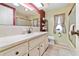 Bathroom with neutral tones, featuring a white vanity, toilet, framed mirror, and good natural light at 12501 Ulmerton Rd # 110, Largo, FL 33774