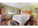 Cozy bedroom featuring a four-poster bed, a ceiling fan and an exterior window at 12501 Ulmerton Rd # 110, Largo, FL 33774