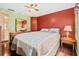 Inviting bedroom featuring wood look flooring, a large window and a comfy bed at 12501 Ulmerton Rd # 110, Largo, FL 33774
