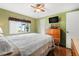 Bedroom featuring a ceiling fan, a window and a decorative dresser at 12501 Ulmerton Rd # 110, Largo, FL 33774