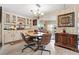 Open dining area with a chandelier, built-in cabinets, and neutral decor for easy personalization at 12501 Ulmerton Rd # 110, Largo, FL 33774